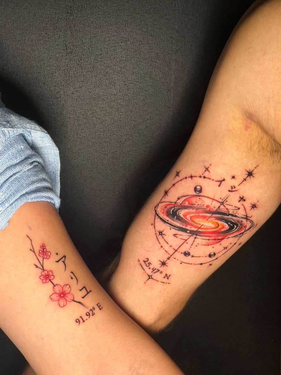 Matching fine line cherry blossom and red galaxy coordinates couple tattoos, Dev Tattoo & Art Kolkata