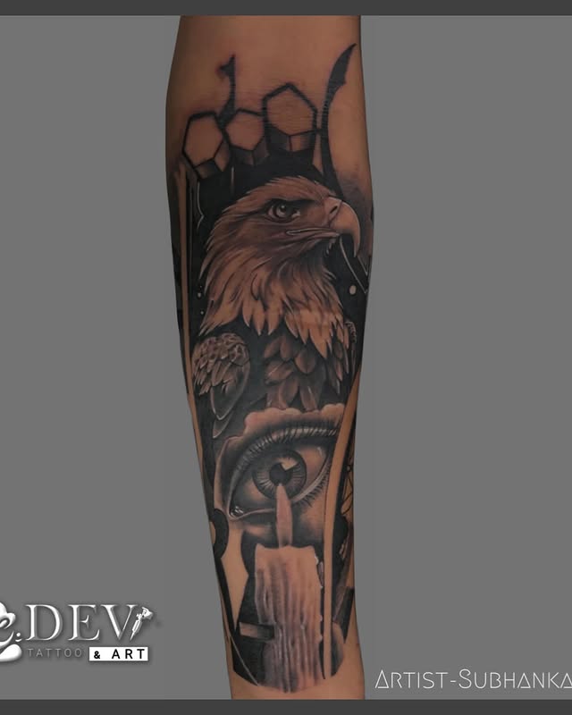 Black and grey realism forearm sleeve with eagle, eye and candle by Subhankar, Dev Tattoo & Art Kolkata