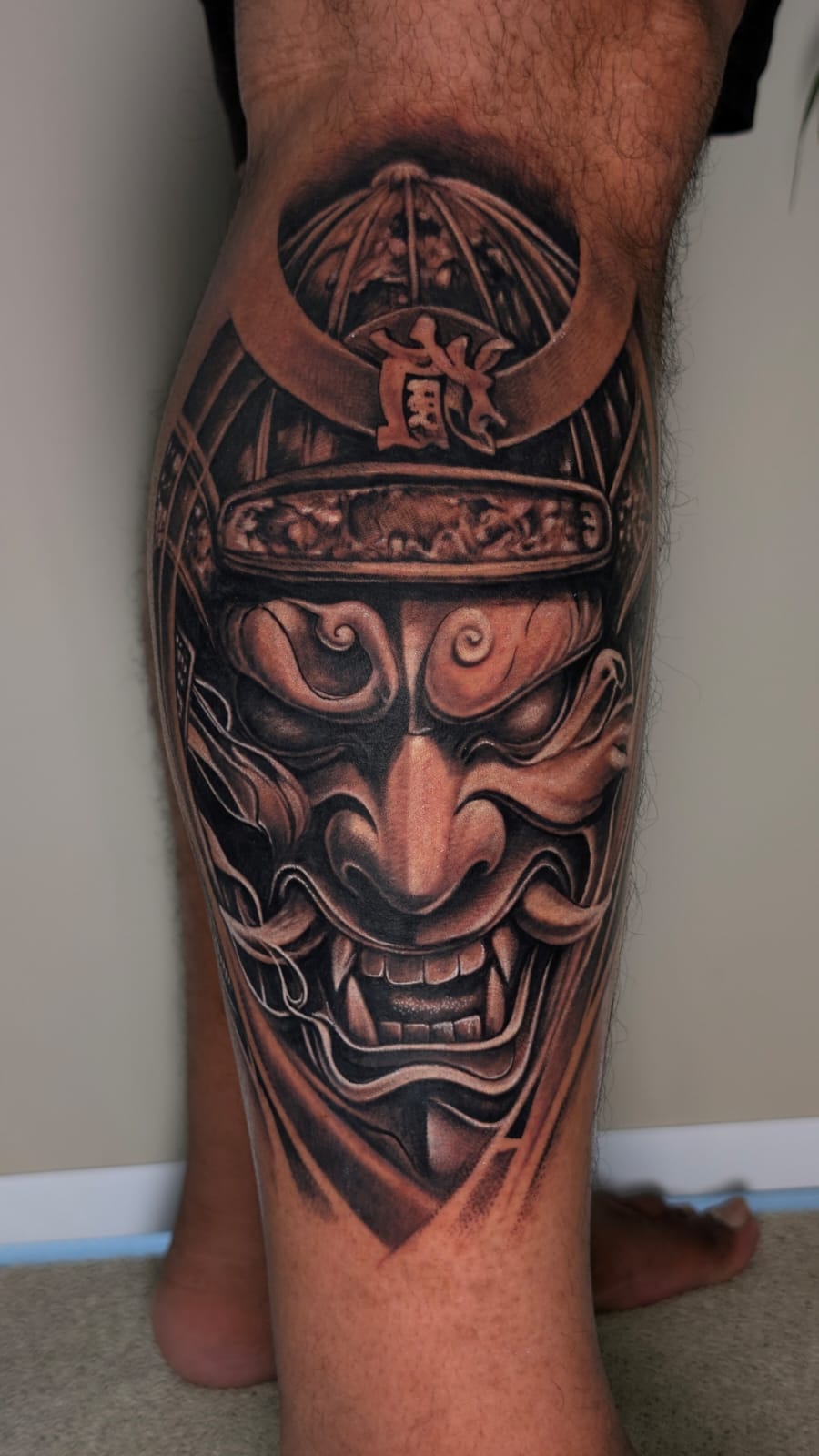 Samurai warrior with Hannya mask black and grey calf tattoo, Dev Tattoo & Art Kolkata