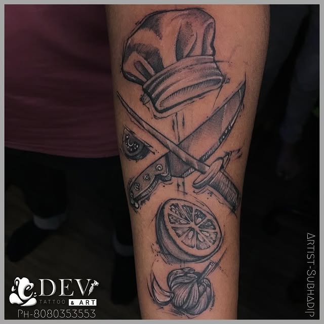 Chef hat with crossed knives illustrative forearm tattoo by Subhadip, Dev Tattoo & Art Kolkata
